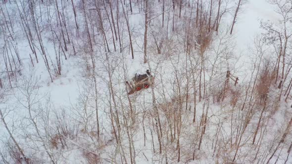 Clearing snow on a rural property with a wheeled bobcat