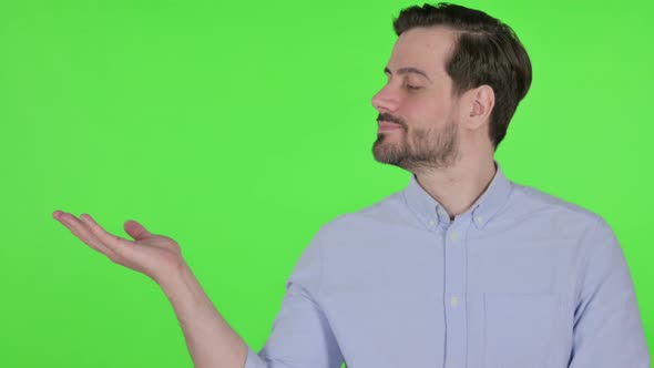Portrait of Man Holding Product on Hand Green Screen