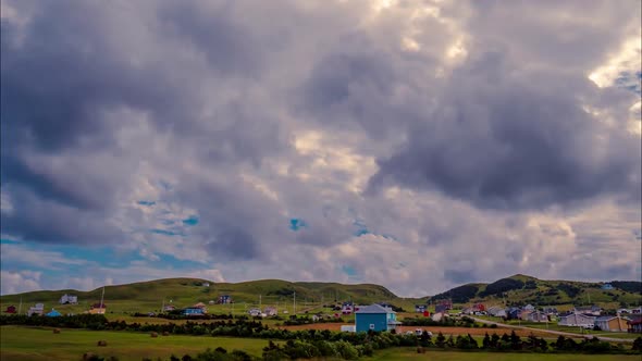 Amazing time lapse of blue sky and bright white clouds blowing over a quaint village in the Magdalen