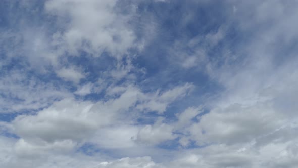 TIME LAPSE - rolling white clouds on a beautiful blue sky