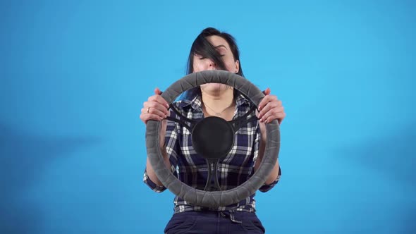 Portrait Woman Driver Gets Into an Accident on a Blue Background Isolate