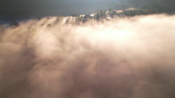 Aerial view from drone, Epic sunbeam over sea of clouds mountains. 4K aerial shot on sunrise