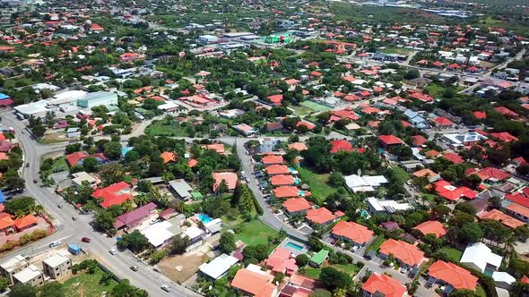 Tilt down aerial view of tile-roofed houses in Mahaai Buurt, Willemstad, Curacao, Dutch Carribean is