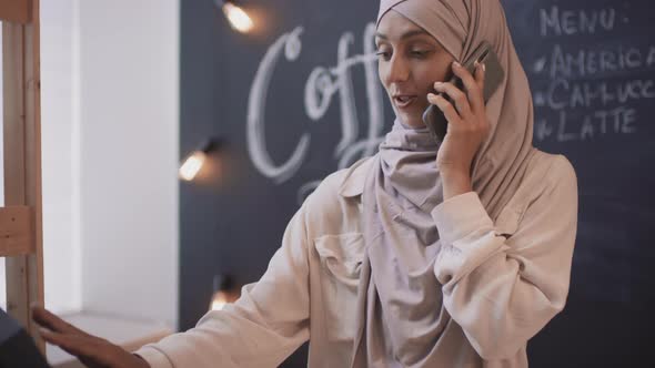 Muslim Cafeteria Businesswoman Talking On Phone