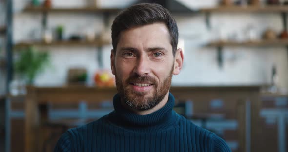 Closeup Portrait of Successful Caucasian Man Smiling Looking at Camera While Sitting at Home on Sofa