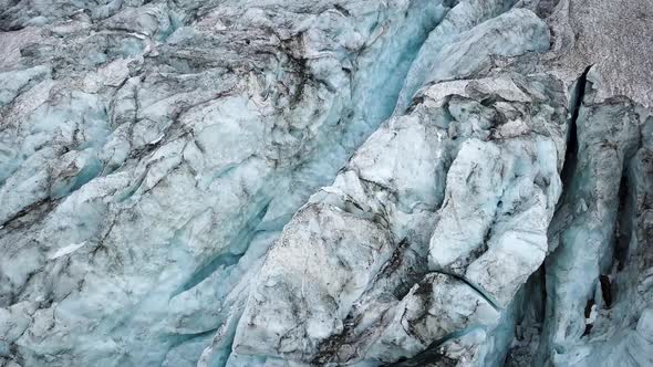 Aerial detail of a glacier crack seen topdown in the swiss alps in Europe