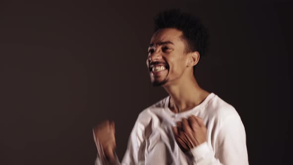 Portrait of Happy Excited African Man in White Showing YES Sign Gesture