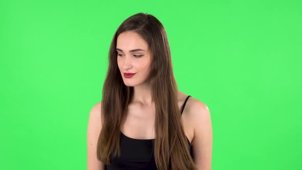 Charming Girl Looks Around and Whispers the Secret and Making a Hush Gesture. Green Screen