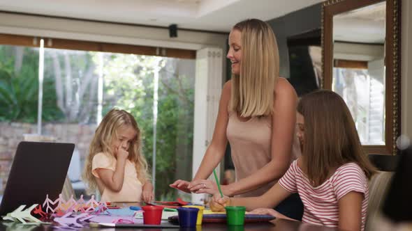 Mother and daughters painting together