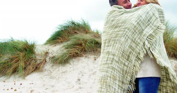 Romantic couple embracing each other in shawl