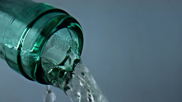 Transparent Bottle Pouring Wine Closeup