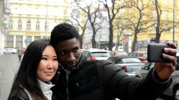 Happy Couple Take Photo - Black Man and Asian Woman - Urban Street with Cars - City