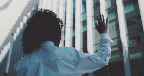 Young african woman raising her hand