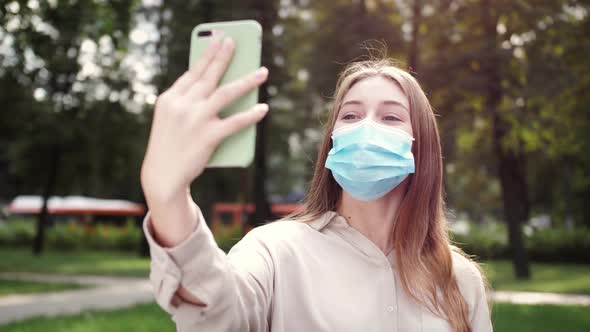 Young woman makes video call on smartphone.