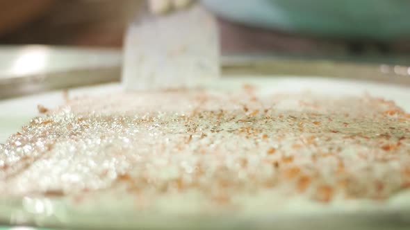 Chef Making Ice Cream Rolls on Freeze Pan. Preparation of Thailand Ice-cream