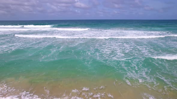 Top view tropical beach Amazing waves sea background. Crashing waves on beach sand, Beautiful sea