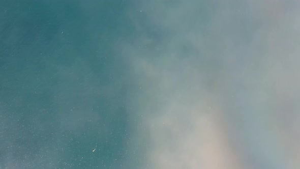 Panorama Of Feathery Clouds Under The Blue Ocean And The Green Landscape In Westfjords