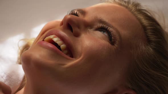 Smiling Blonde Model Lying on Bed