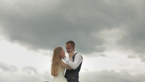 Groom with Bride Together on Sky Background. Wedding Couple. Happy Family