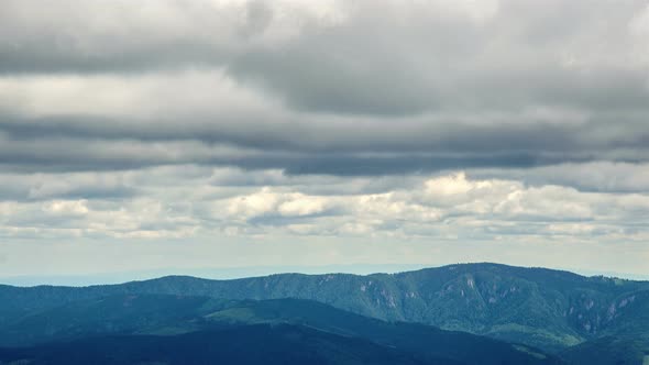 Dark Clouds Moving over Mountain and Forest