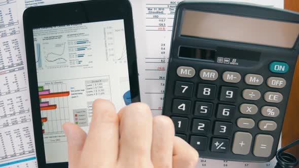 Businessman Working On The Tablet, Calculating Data And Calling By Black Phone 