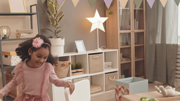 Little Mixed-Race Sisters Running Around Room