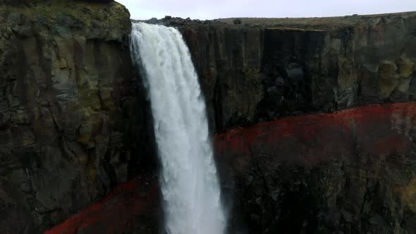Aerial View on Hengifoss Waterfall with Red Stripes Sediments