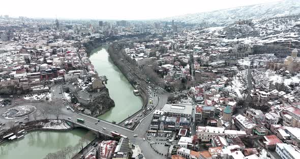 Aerial view of Metekhi church in old Tbilisi located on cliff near river Kura. Georgia 2022 winter