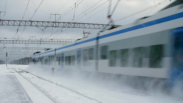 Intercity Modern Electric Train Rides on Snowcovered Rails