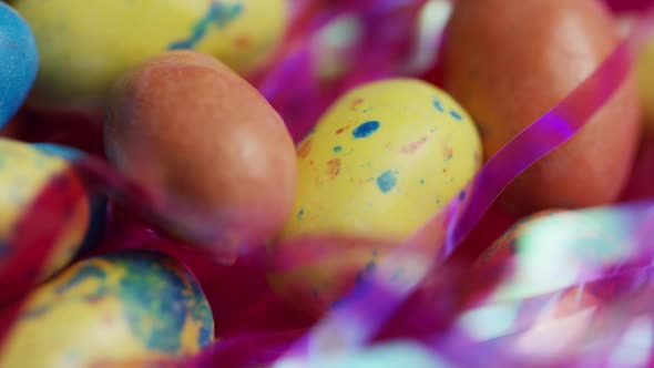 Rotating shot of colorful Easter candies on a bed of easter grass 