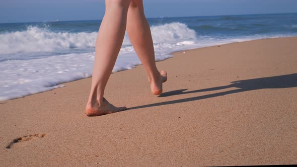 Beach Travel Woman Walking on Sand Beach Leaving Footprints in Sand