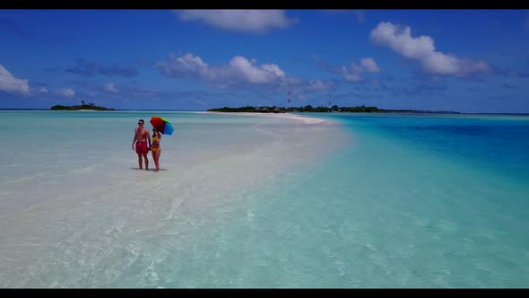 Teenage lovers happy together on relaxing bay beach wildlife by shallow sea with white sand backgrou