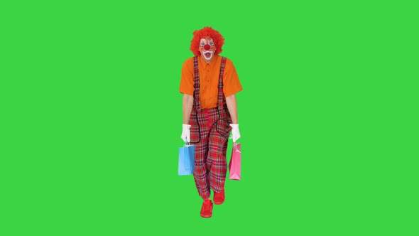 Tired Clown with Shopping Bags Walking on a Green Screen Chroma Key