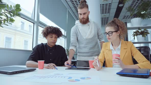 Business Team Discussing Growth Graphs in Office