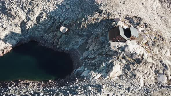 Cabin of Orny, alpine lake and rocky mountains, Switzerland, drone aerial view