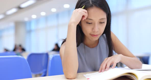 Young Woman study at university library 