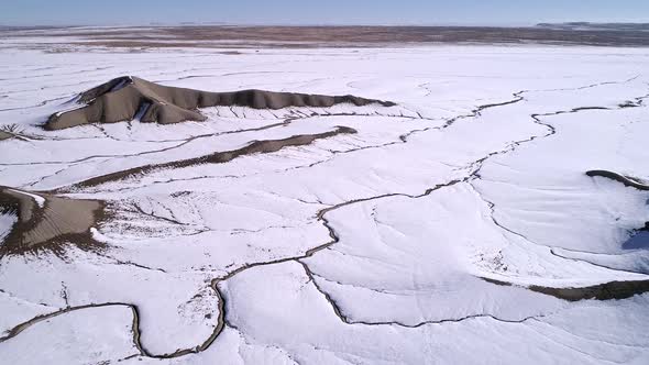 Aerial view of flat desert landscape covered in snow