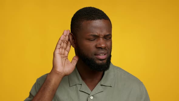 Curious African American Man Keeping Hand Near Ear Trying To Overhear Information