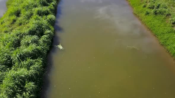 Drone rising up over a fishing pond on a fish farm in rural Brazil