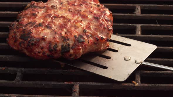 Top Closeup View of the Homemade Burger Cutlet Flipped on the Grill Grid