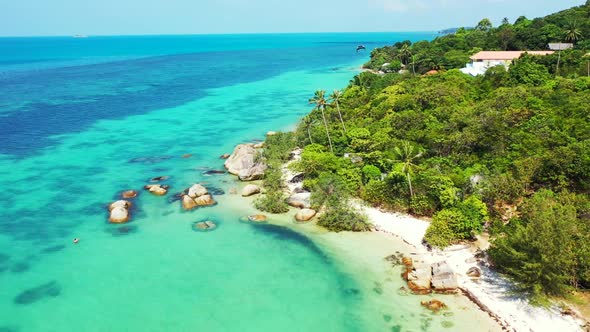 Aerial drone shot landscape of paradise shore beach journey by blue green sea with white sand backgr