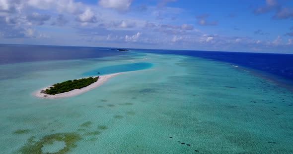 Daytime drone abstract shot of a white paradise beach and blue water background in 4K