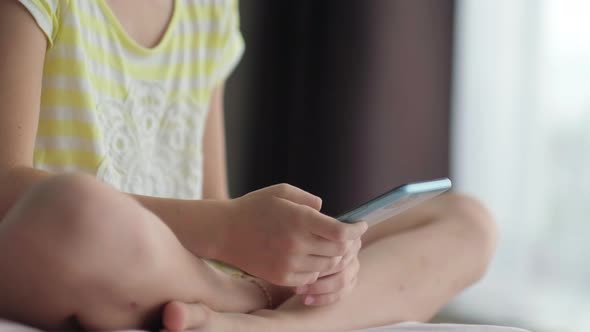 Little Girl Using Mobile Phone at Home