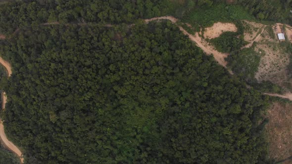 Aerial: flying over rice paddies unique valley scenic cliffs rock pinnacles tropical jungle stunning