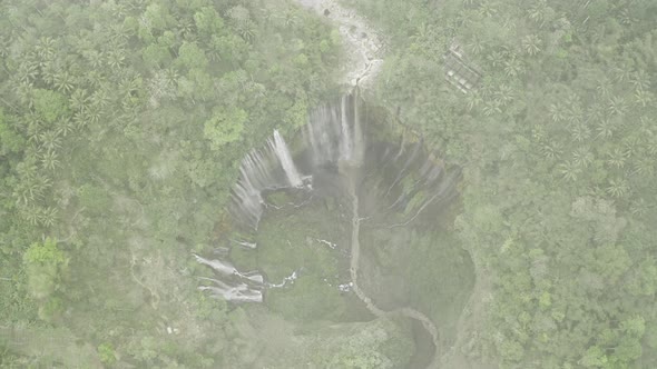 Drone Tilting Up Through Mist Over Tumpak Sewu Waterfalls