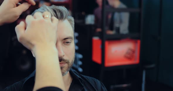 Barber Corrects the Hair of the Client