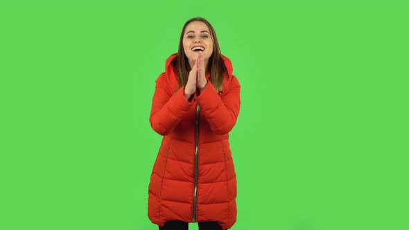 Lovely Girl in a Red Down Jacket Is Clapping Her Hands with Wow Happy Joy and Delight. Green Screen