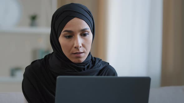 Focused Ethnic Female Muslim Arabian Young Woman Girl Islamic Student Businesswoman Freelancer Sits