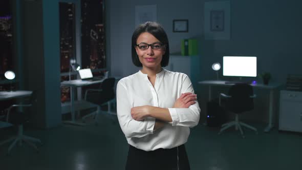 Successful AfricanAmerican Businesswoman Smiling at Camera Working in Big City Office at Night