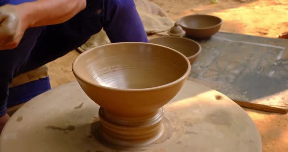 Skilled Hands of Potter Shaping the Clay on Potter Wheel and Sculpting Clay Pot Jar. Shilpagram